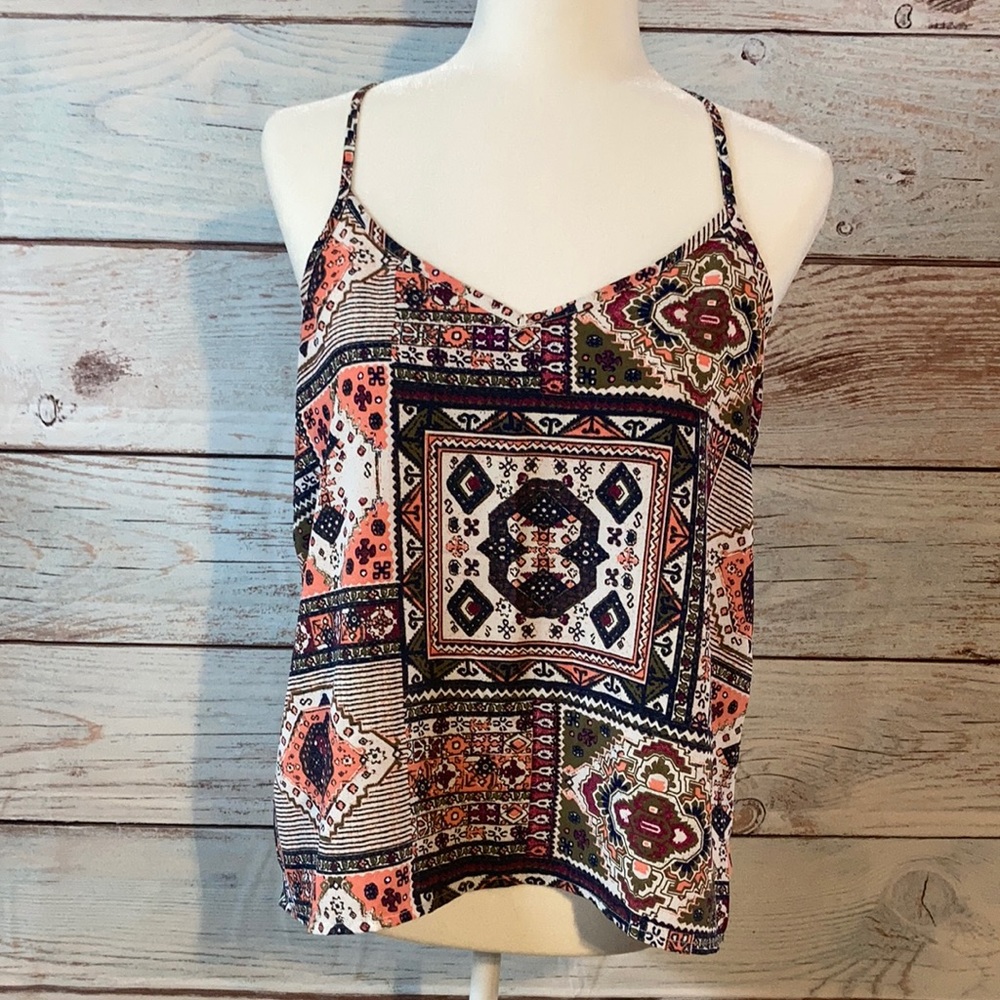 - Medium Hollister spaghetti strap blouse. Criss cross strap on back.